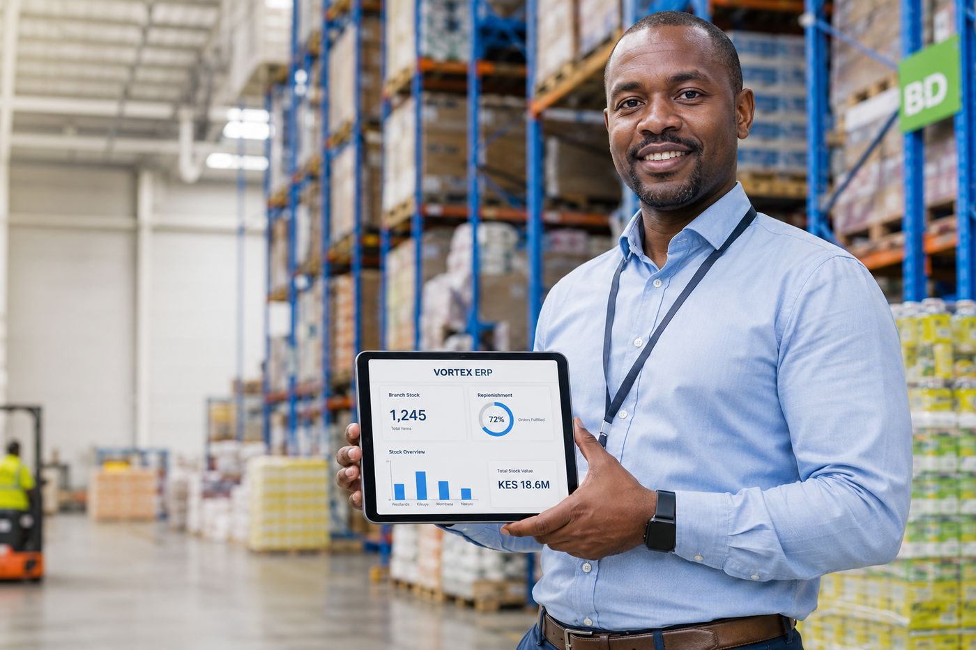 A retail operations manager in a distribution centre showing the VortexERP Enterprise branch-stock and replenishment dashboard